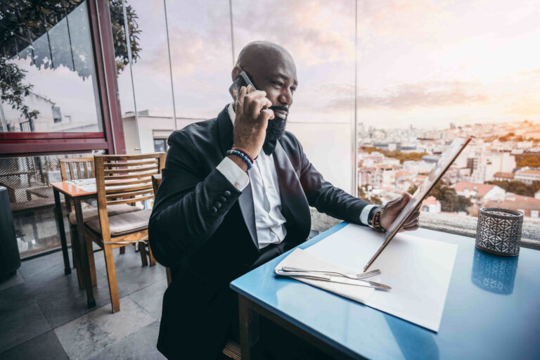 Black man on the phone in a bar